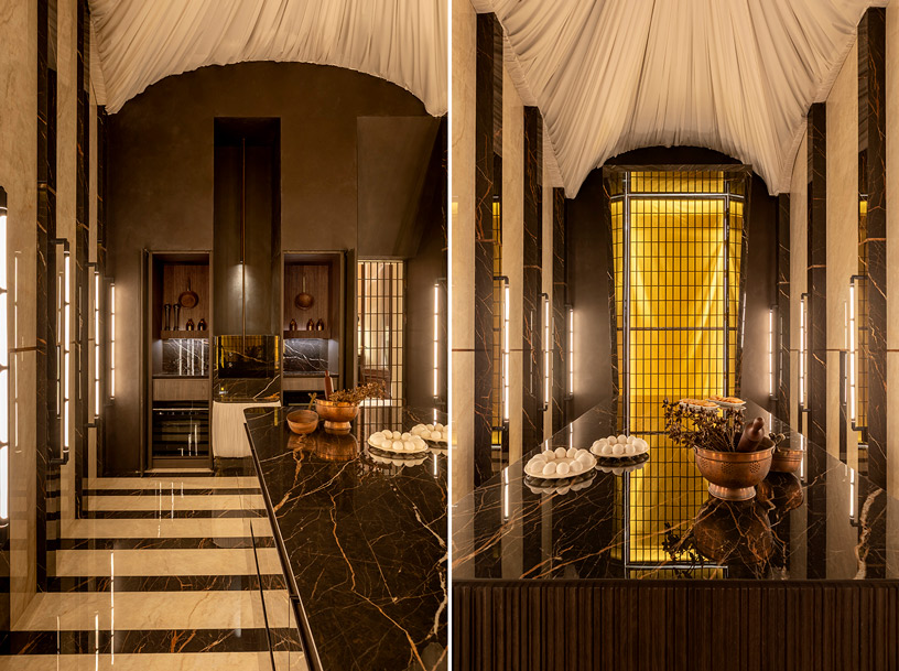 Cocina obrador de inspiración monacal en Casa Decor 2026 diseñada por Viruta Lab con piedra sinterizada Venux, iluminación cálida y estética sobria en tonos chocolate.