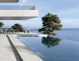Piscina infinity con vistas al mar y pavimento Durstone en una vivienda contemporánea